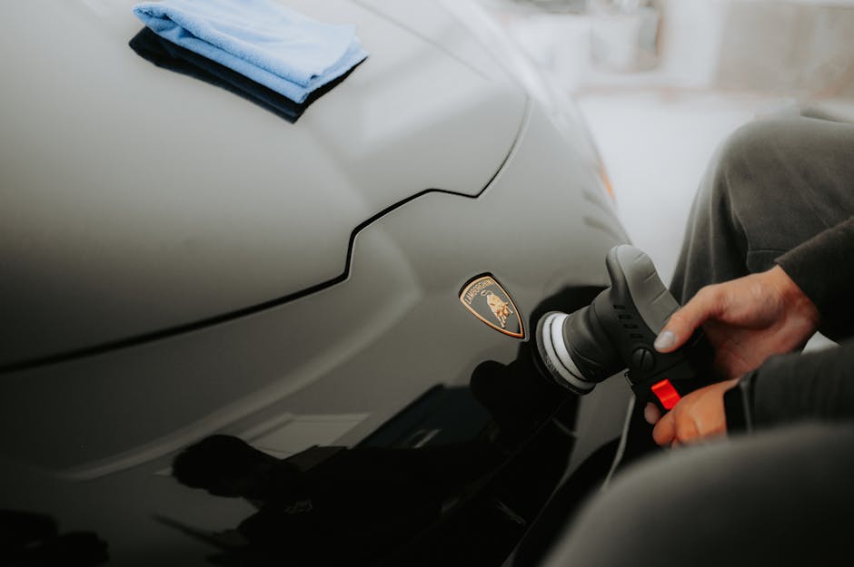 Professional car detailer inspecting a vehicle